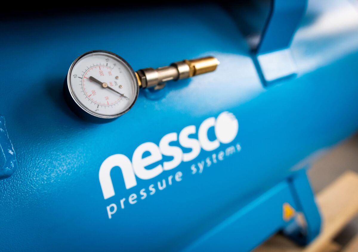 Blue compressor air receiver with pressure gauge.