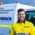 Nessco Pressure Systems (NPS) compressor service technician smiles and wears a high-vis yellow work shirt. He stands in front of a white NPS work vehicle.